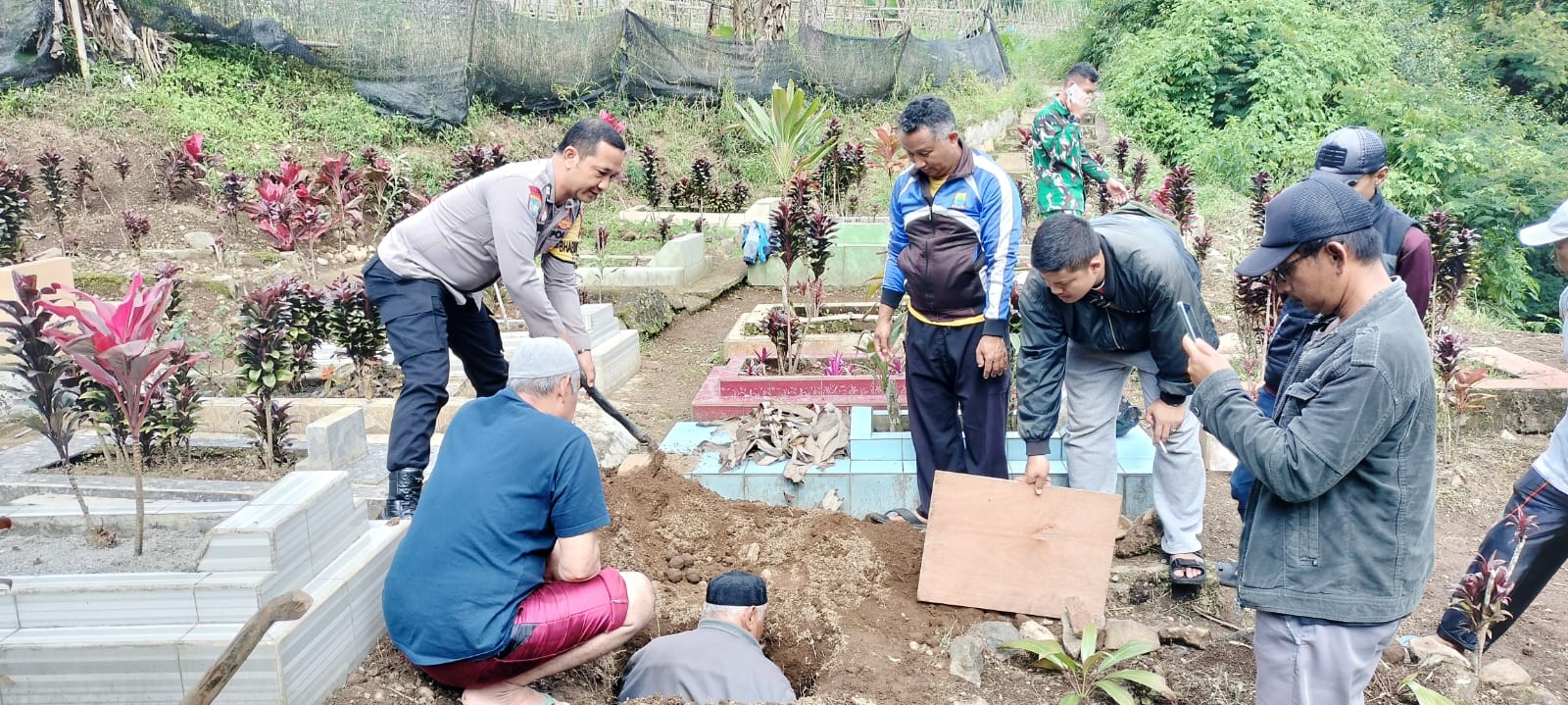 Teks: Polisi dan warga melakukan pemakaman jenazah bayi di Pacet Cianjur