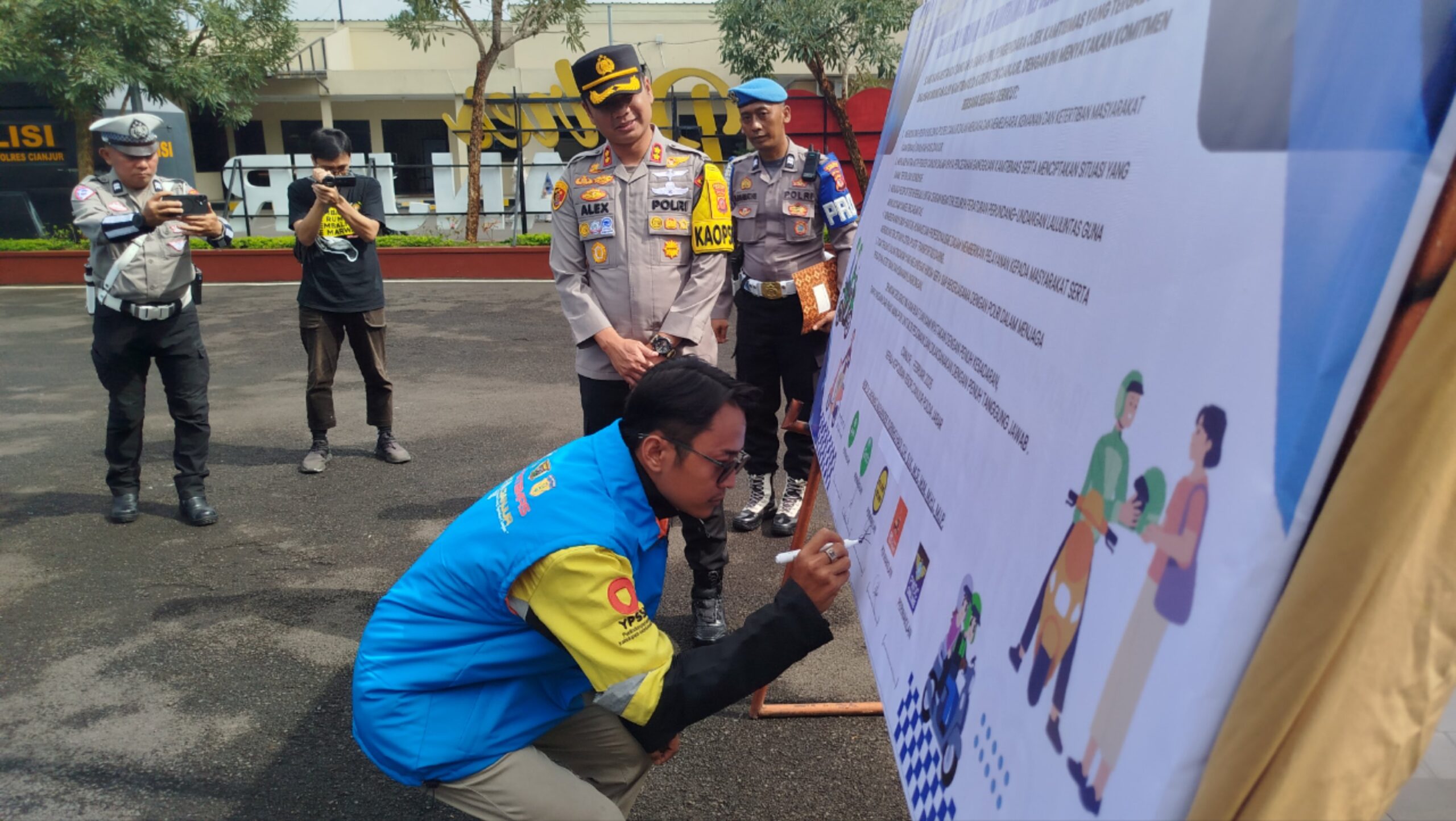 Teks: Perwakilan ojek menandatangani deklarasi Ojek Kamtibmas di Lapang Upacara Polres Cianjur disaksikan pimpinan kepolisian.