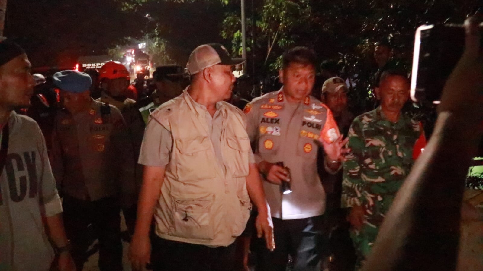 Teks: Kapolres Cianjur meninjau lokasi banjir bandang Jamali bersama petugas di Cianjur
