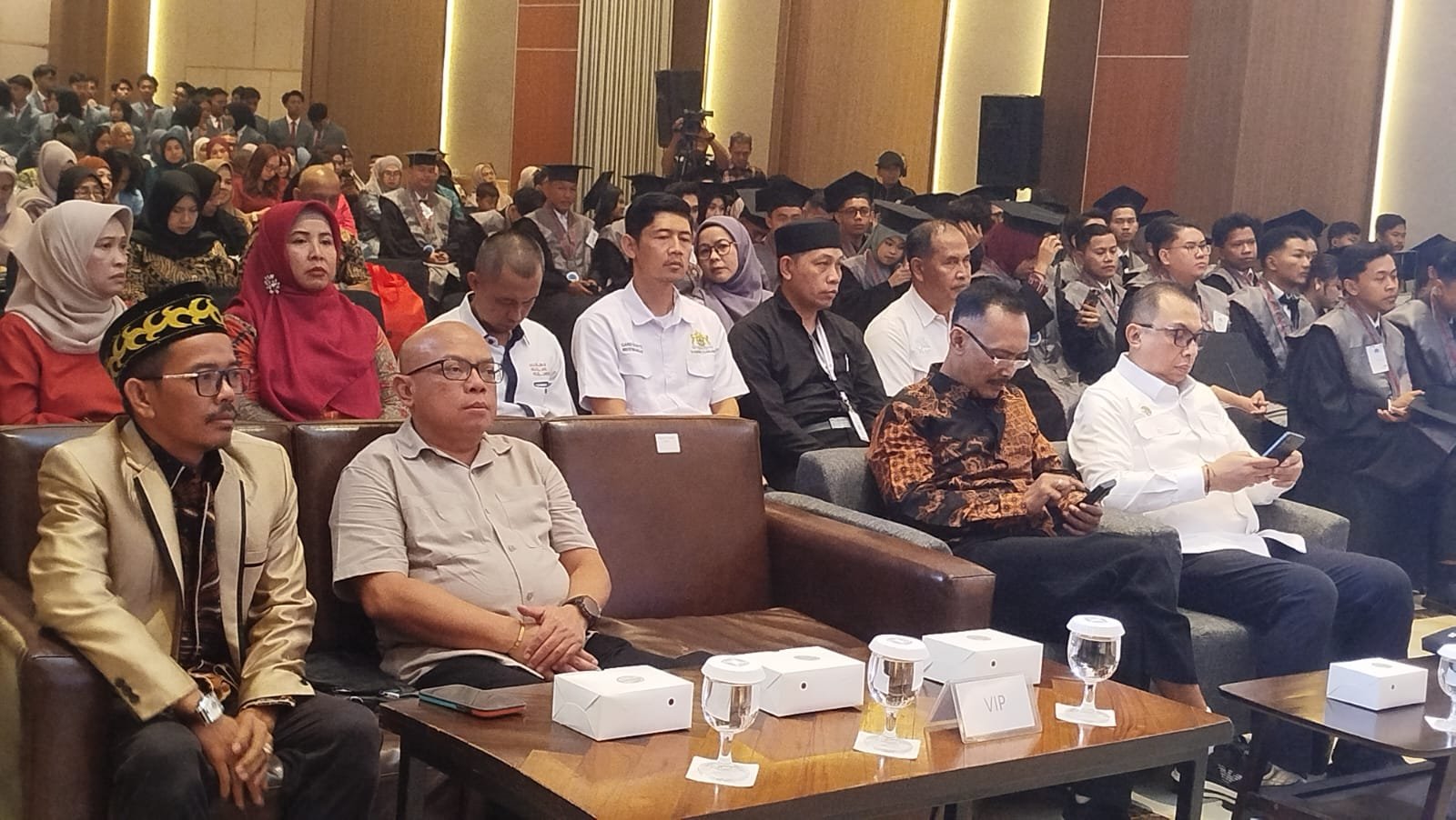 Teks: Wisudawan Abdi Bangsa Institute Cianjur bersama unsur Forkopimda dan tamu undangan menghadiri acara wisuda di Cordela Suites Hotel.